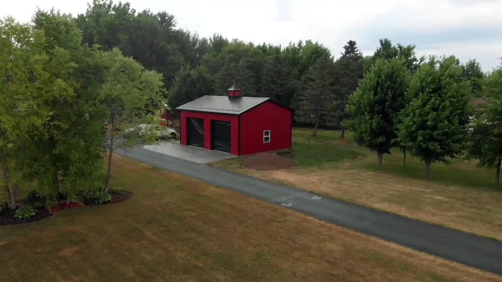 Red two car post frame pole barn garage in Clarence, NY. Constructed by Stately Post Frame.