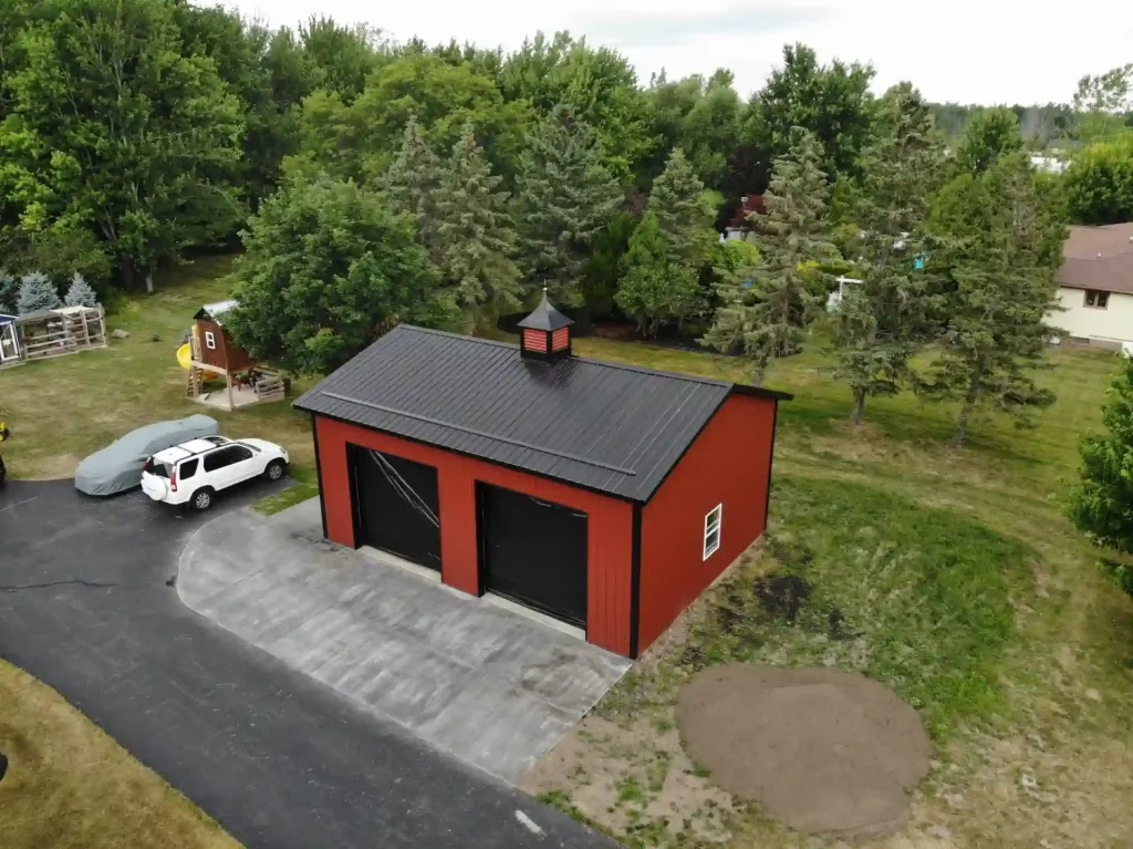 Red two car post frame pole barn garage in Clarence, NY. Constructed by Stately Post Frame.