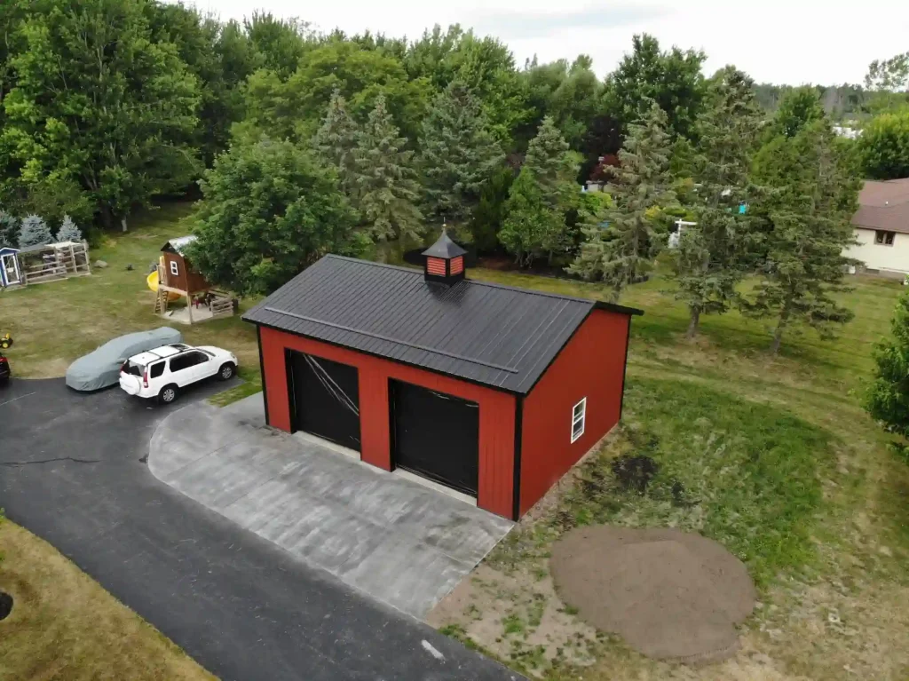 Red two car post frame pole barn garage in Clarence, NY. Constructed by Stately Post Frame.