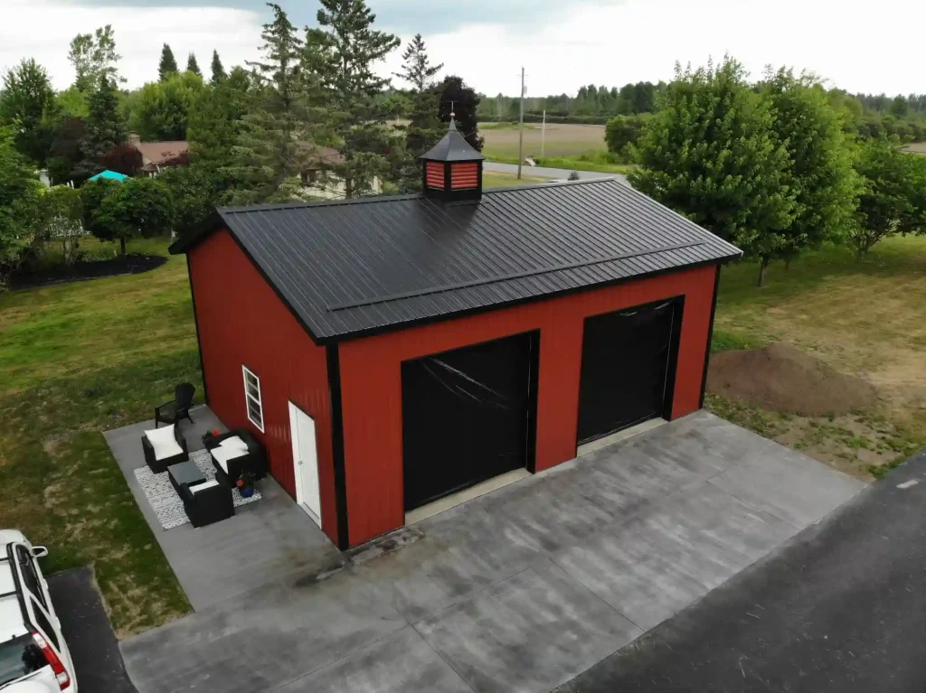 Red two car post frame pole barn garage in Clarence, NY. Constructed by Stately Post Frame.