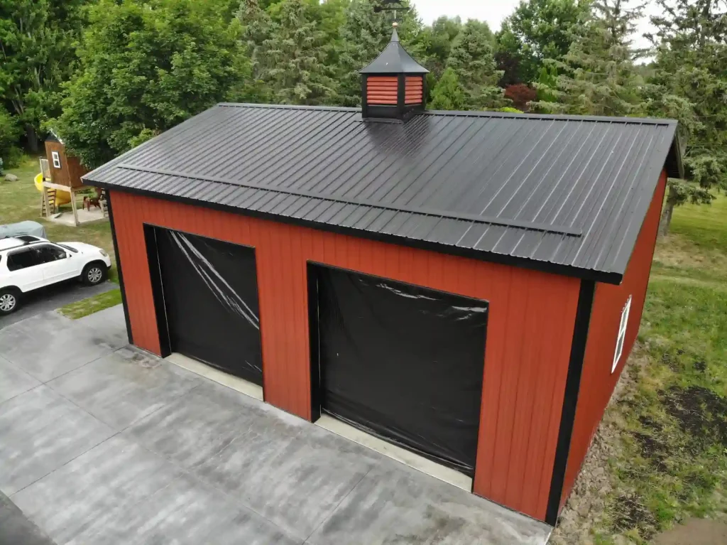 Red two car post frame pole barn garage in Clarence, NY. Constructed by Stately Post Frame.