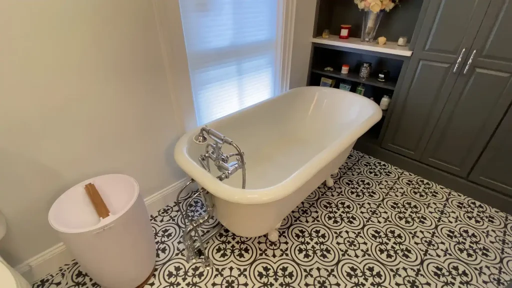 Clawfoot tub. Built-in storage. Retro and elegant style luxury bathroom remodel by Stately Kitchen and Bath in Lockport, NY.