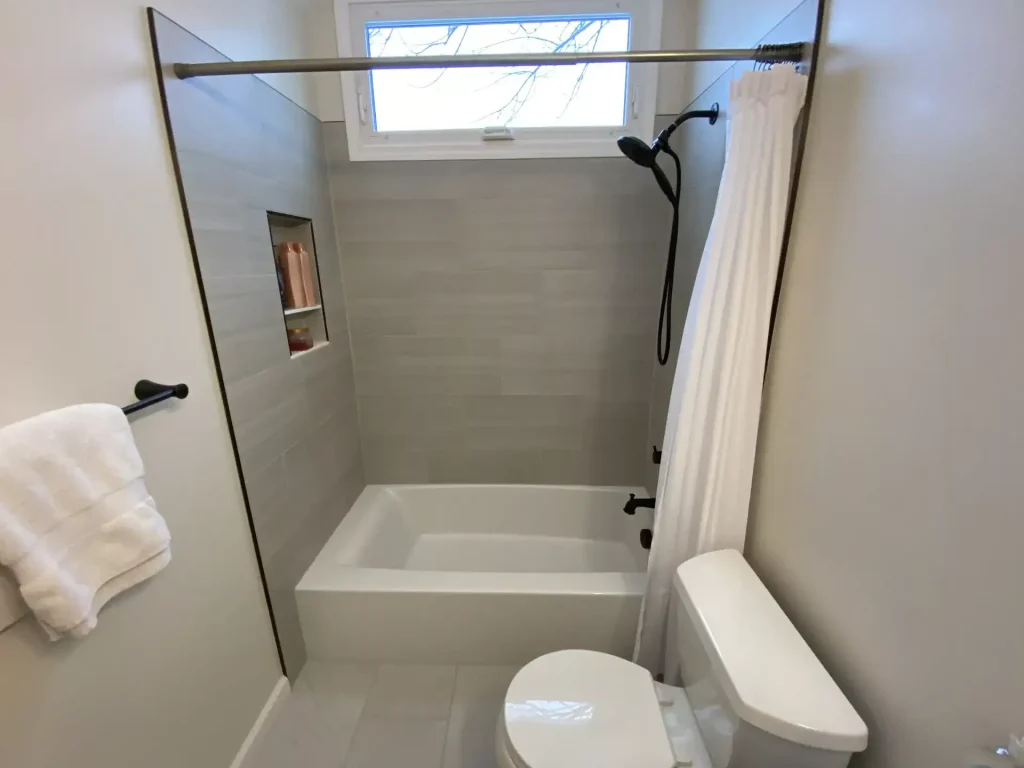 Toilet and shower. Second upstairs bathroom remodel in Clarence, NY by Stately Kitchen and Bath.