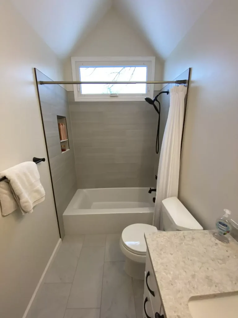 Toilet and shower. Second upstairs bathroom remodel in Clarence, NY by Stately Kitchen and Bath.