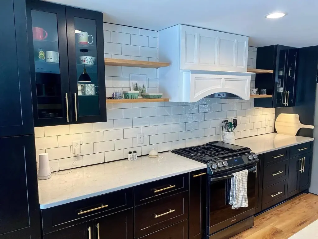 Kitchen overview. Trendy black and white kitchen by Stately Kitchen and Bath in Clarence Center, NY.