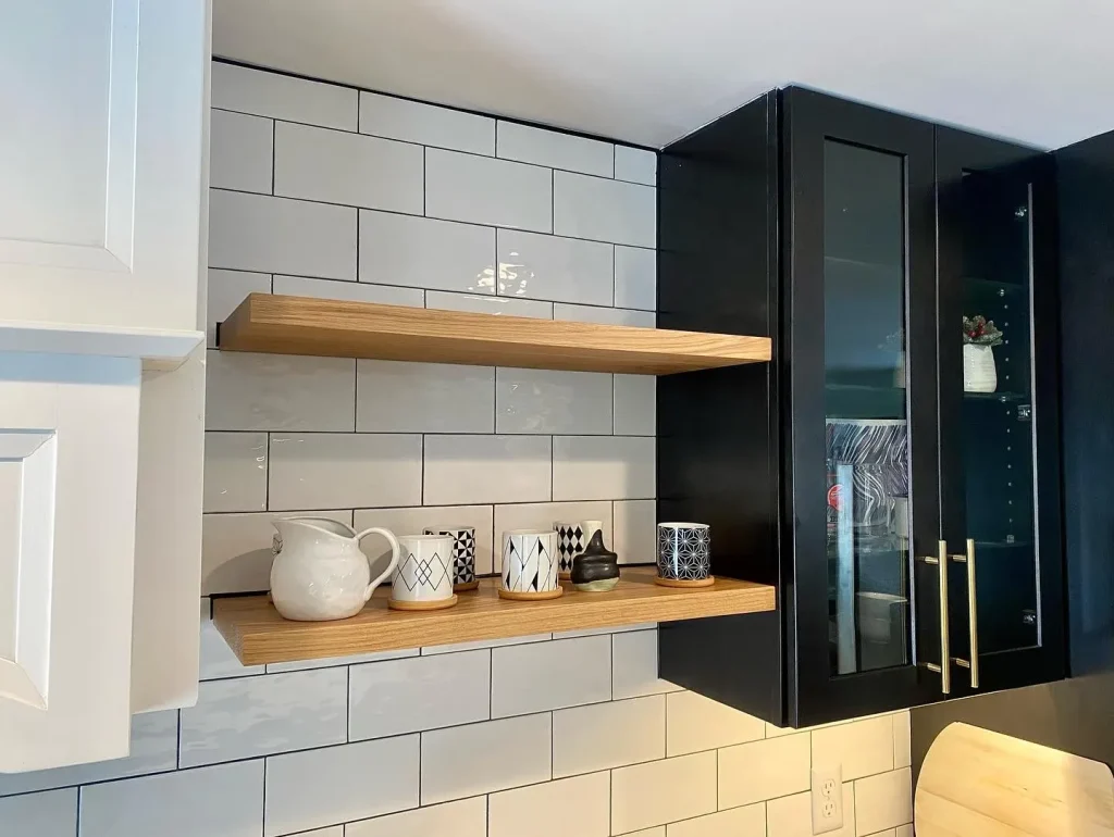 Cupboards and shelving. Trendy black and white kitchen by Stately Kitchen and Bath in Clarence Center, NY.