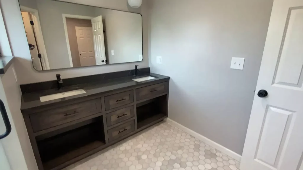 Rusch Woodworking custom vanity in a luxury bathroom remodel by Stately Kitchen and Bath in Clarence, NY.