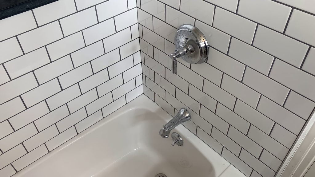 Chrome fixtures and expertly-installed subway tile by Stately Kitchen and Bath in Kenmore, NY.