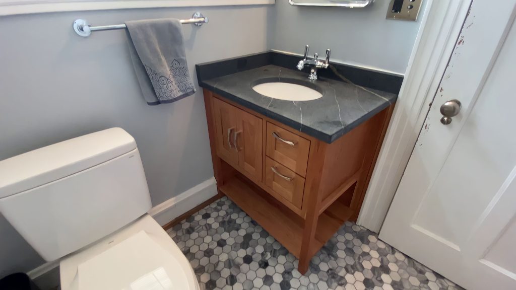 Custom vanity by Reusch Woodworking and bathroom remodel by Stately Kitchen and Bath in Kenmore, NY.