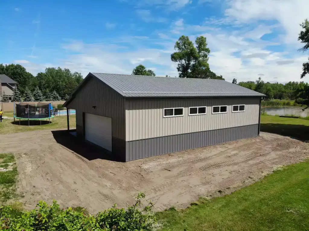 Post frame pole barn garage with lean to and large overhead doors – constructed by Stately Post Frame in Clarence Center, NY.