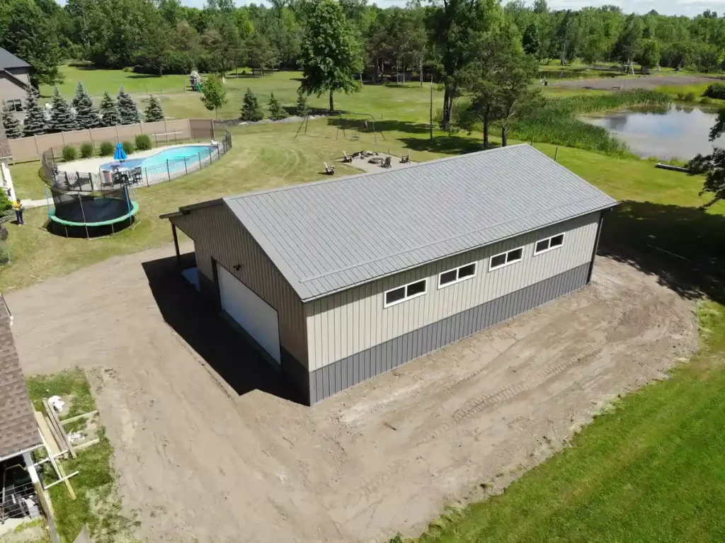 Post frame pole barn garage with lean to and large overhead doors – constructed by Stately Post Frame in Clarence Center, NY.