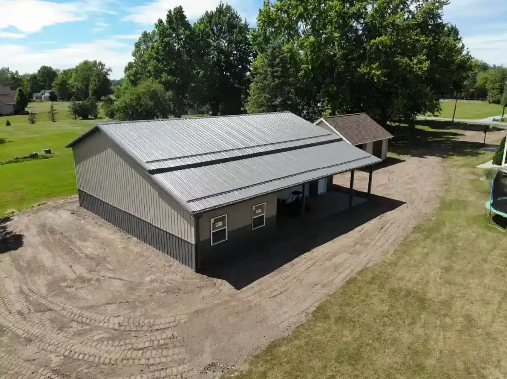 Post frame pole barn garage with lean to and large overhead doors – constructed by Stately Post Frame in Clarence Center, NY.