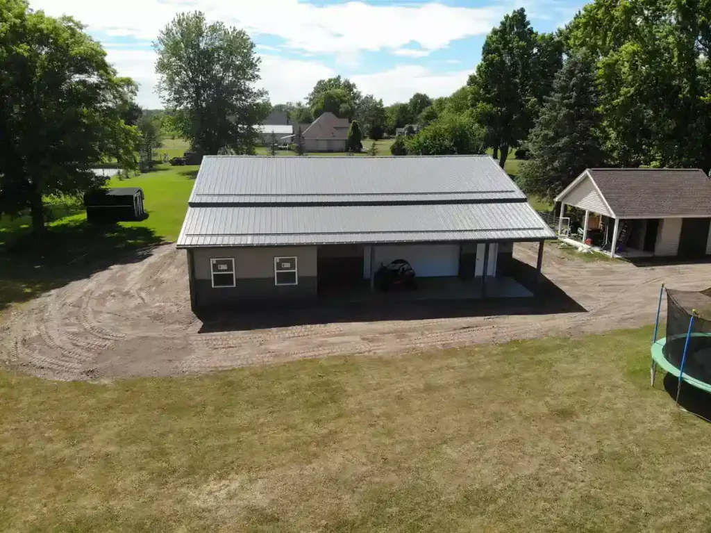 Post frame pole barn garage with lean to and large overhead doors – constructed by Stately Post Frame in Clarence Center, NY.