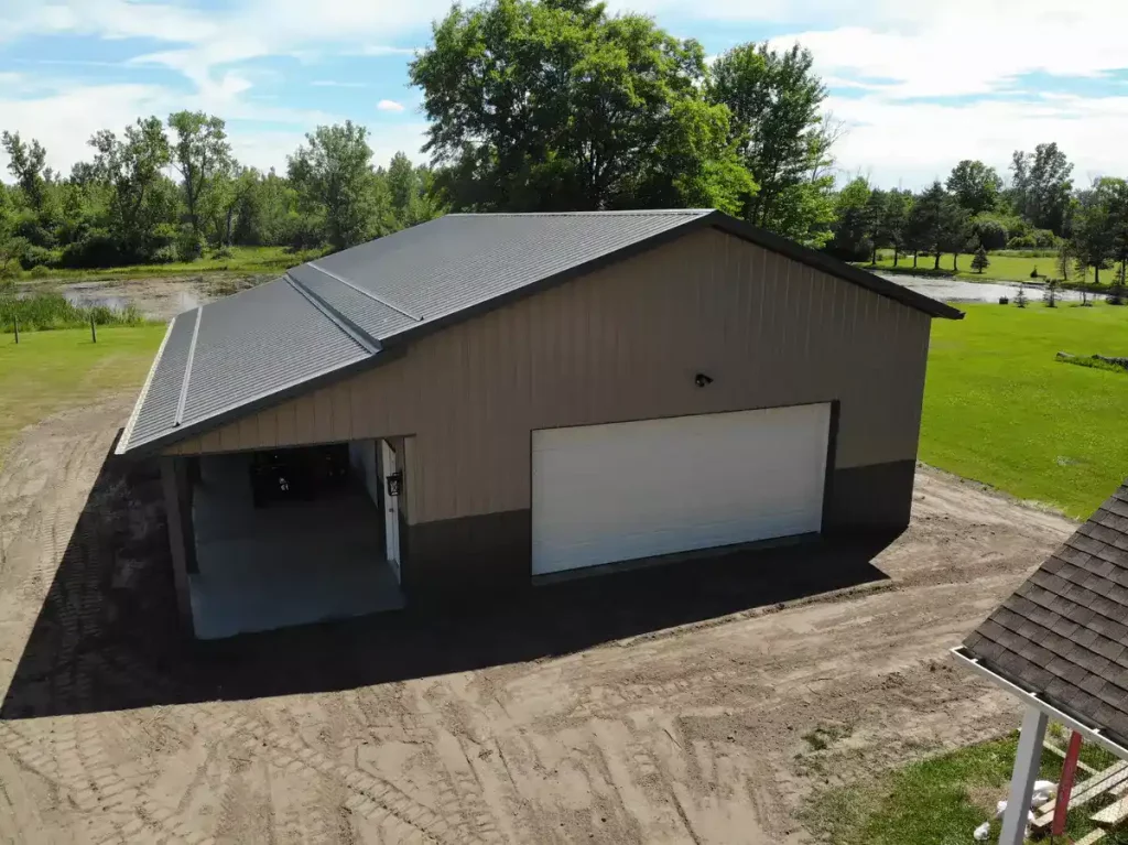 Post frame pole barn garage with lean to and large overhead doors – constructed by Stately Post Frame in Clarence Center, NY.