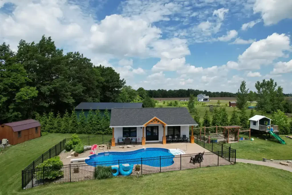 Aerial view of the pool house addition in Akron, NY, showcasing the surrounding landscape and custom millwork details by Stately General Contracting.