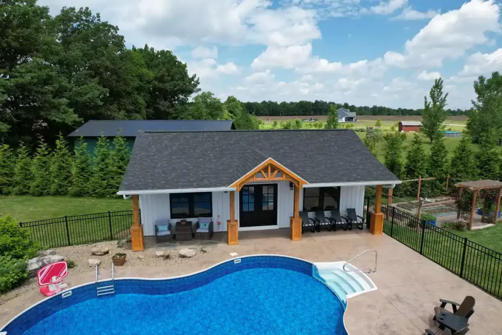 Front view of the pool house addition in Akron, NY, featuring a pool and custom millwork pillars, a project by Stately General Contracting.