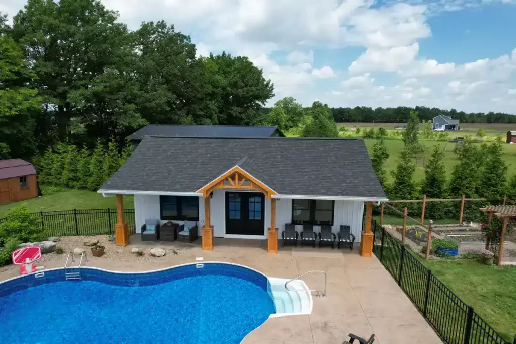 Close-up of the pool house addition in Akron, NY, highlighting the pool and custom millwork under the overhang, designed by Stately General Contracting.