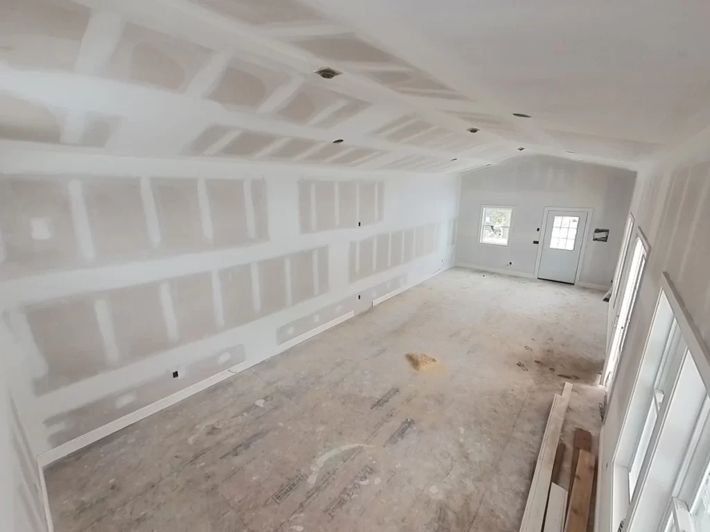 View of pool house interior with completed drywall installation, highlighting the spacious layout.