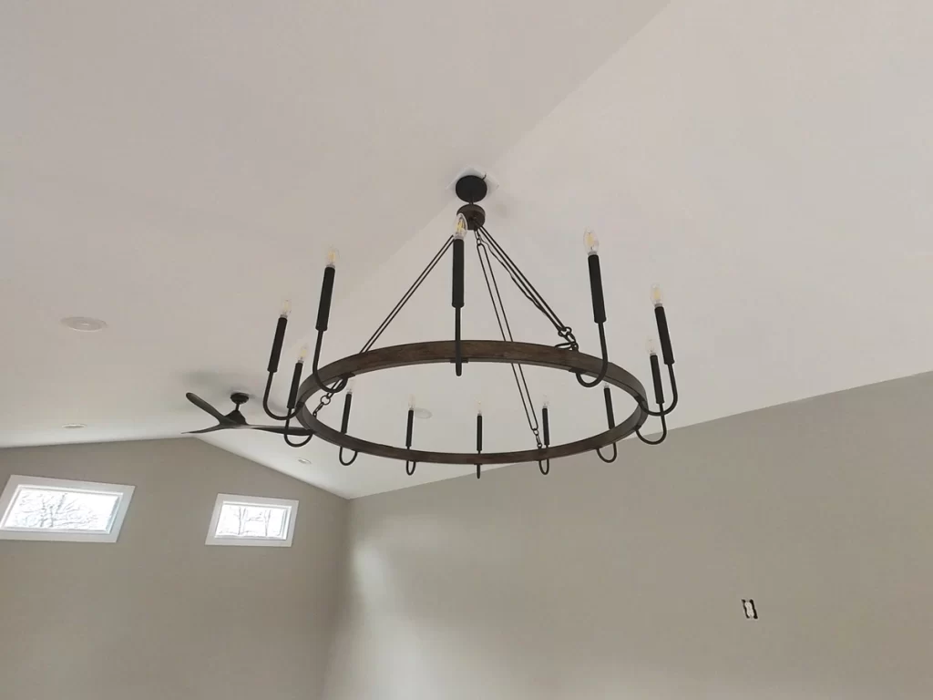 Close-up of a large rustic chandelier installed in the pool house ceiling.