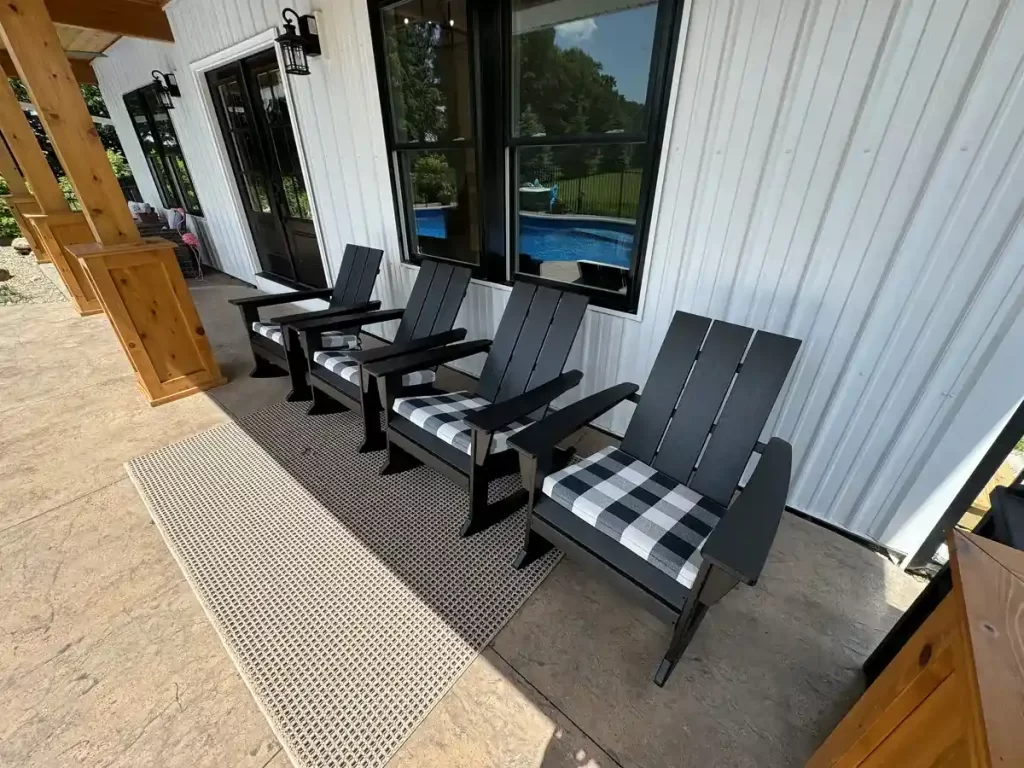 Front porch of the pool house addition in Akron, NY, with Adirondack chairs under the overhang, a project by Stately General Contracting.