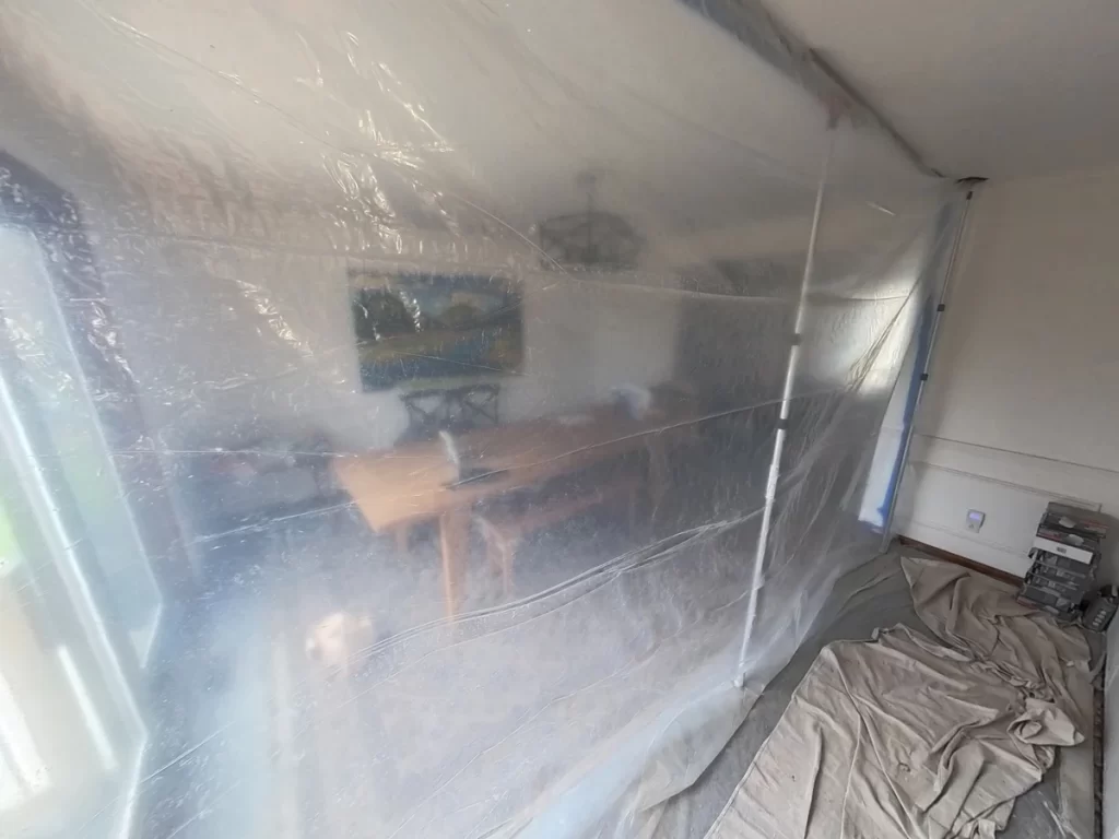 Plastic sheeting covering dining area during kitchen renovation by Stately Kitchen and Bath.