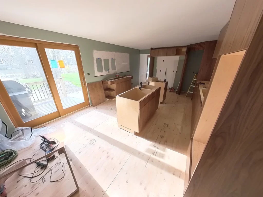 Installation of new cabinets and island during kitchen remodel by Stately Kitchen and Bath.