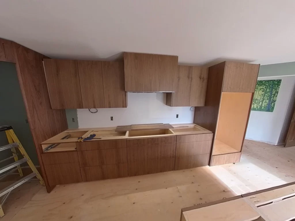 Custom cabinets and hood installation in kitchen remodel by Stately Kitchen and Bath.