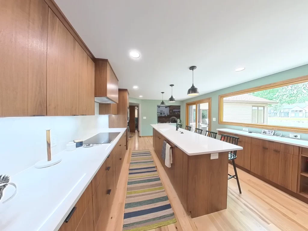 Bright and spacious kitchen remodel with large windows and custom island by Stately Kitchen and Bath.