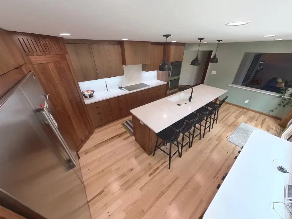 Overhead view of remodeled kitchen by Stately Kitchen and Bath featuring custom cabinets and large island.