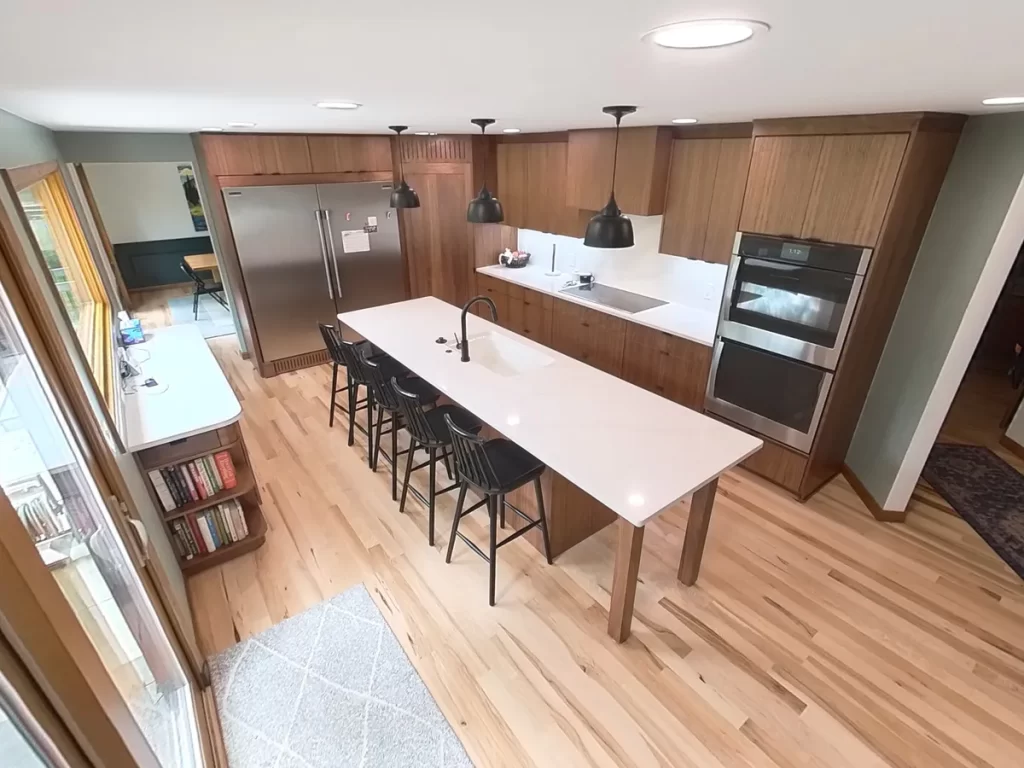 Bright kitchen remodel with large windows and spacious island by Stately Kitchen and Bath.