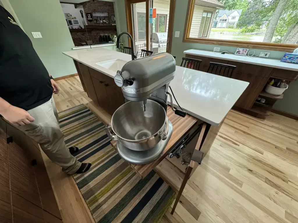 Kitchen island with built-in KitchenAid mixer on pull-out shelf in Buffalo, NY after Stately Kitchen Remodel.