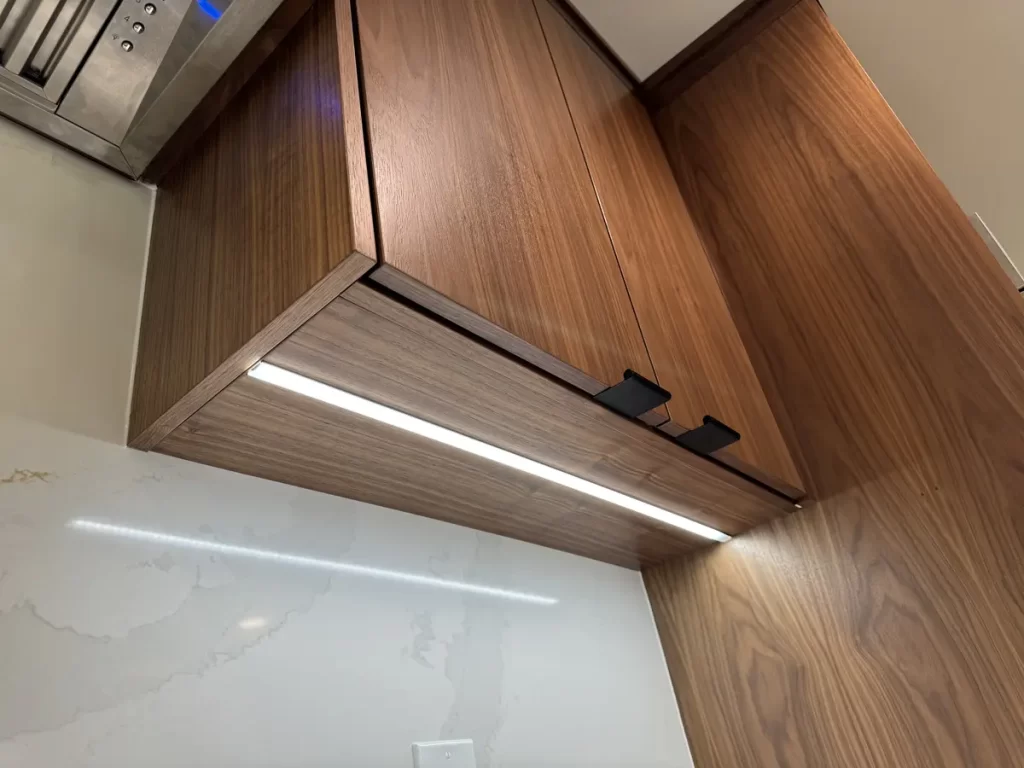 Under-cabinet lighting and sleek kitchen design in Buffalo, NY after Stately Kitchen Remodel.