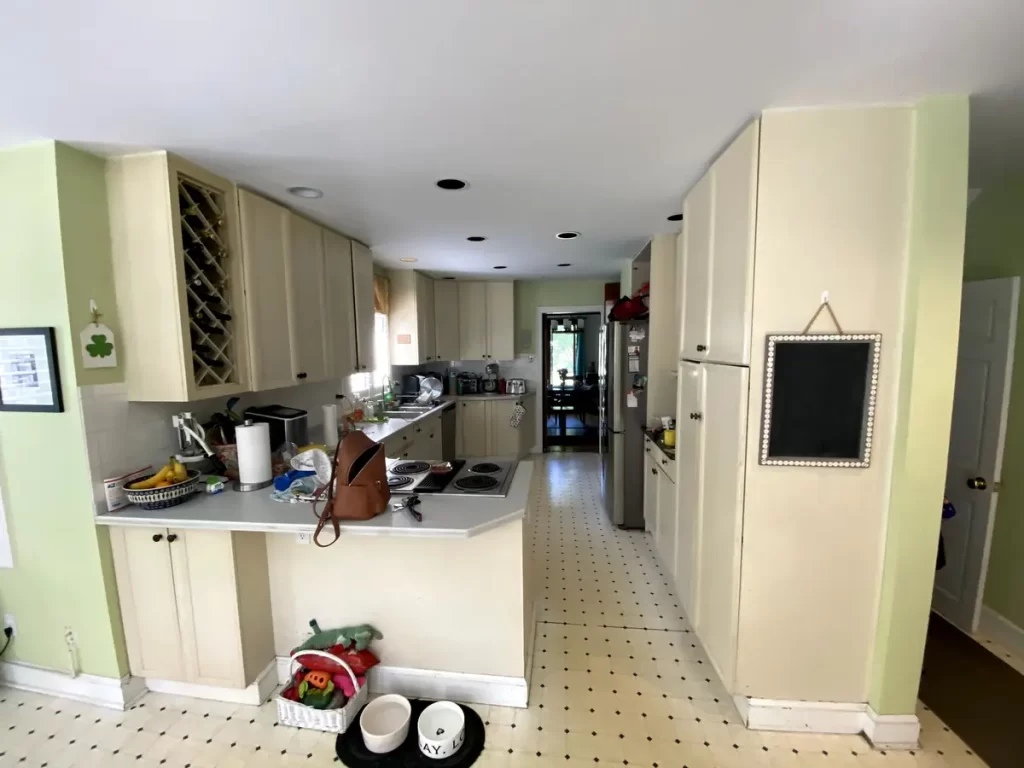 Dated kitchen with white cabinets and countertops in Buffalo, NY before renovation.