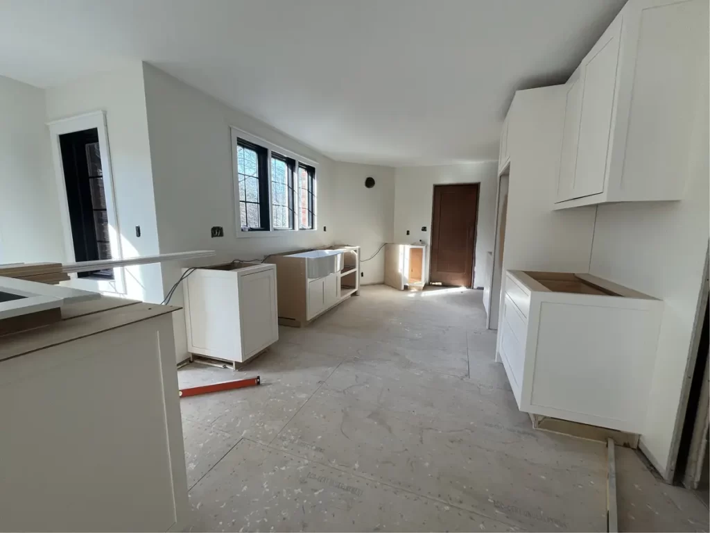 Construction phase of kitchen remodel with new cabinets and windows in Amherst, NY by Stately Kitchen and Bath.