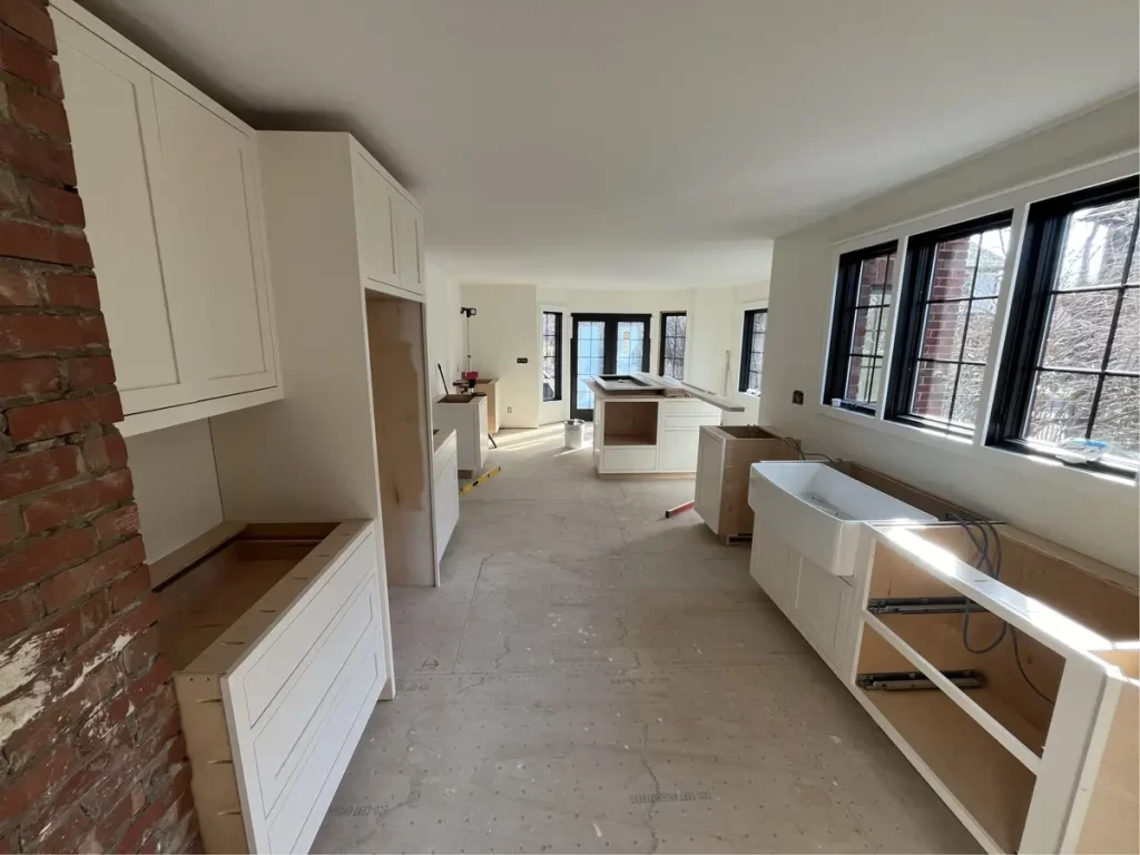 Kitchen remodel in Amherst, NY - construction stage with exposed insulation and framing.