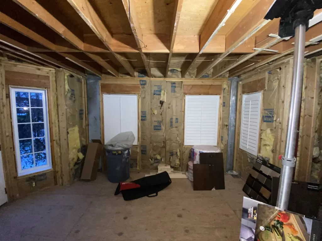 Kitchen remodel in Amherst, NY - construction stage with framed walls and new window installation.