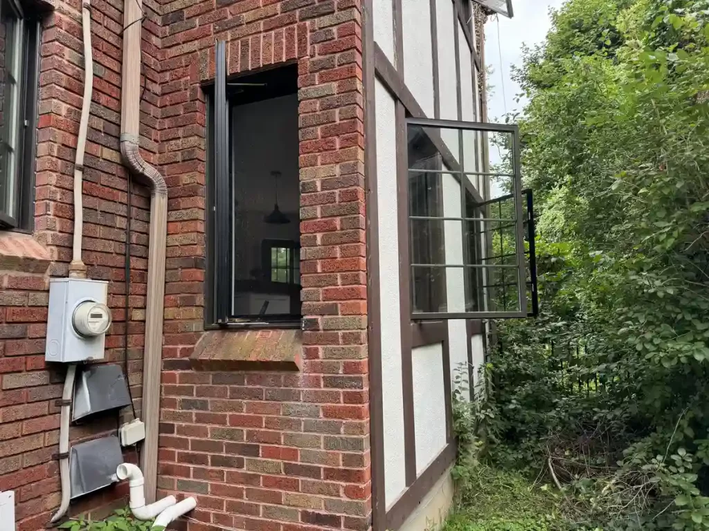 Exterior view of a home with new windows and matching masonry work on the brick facade in Amherst, NY after renovation by Stately Kitchen and Bath.