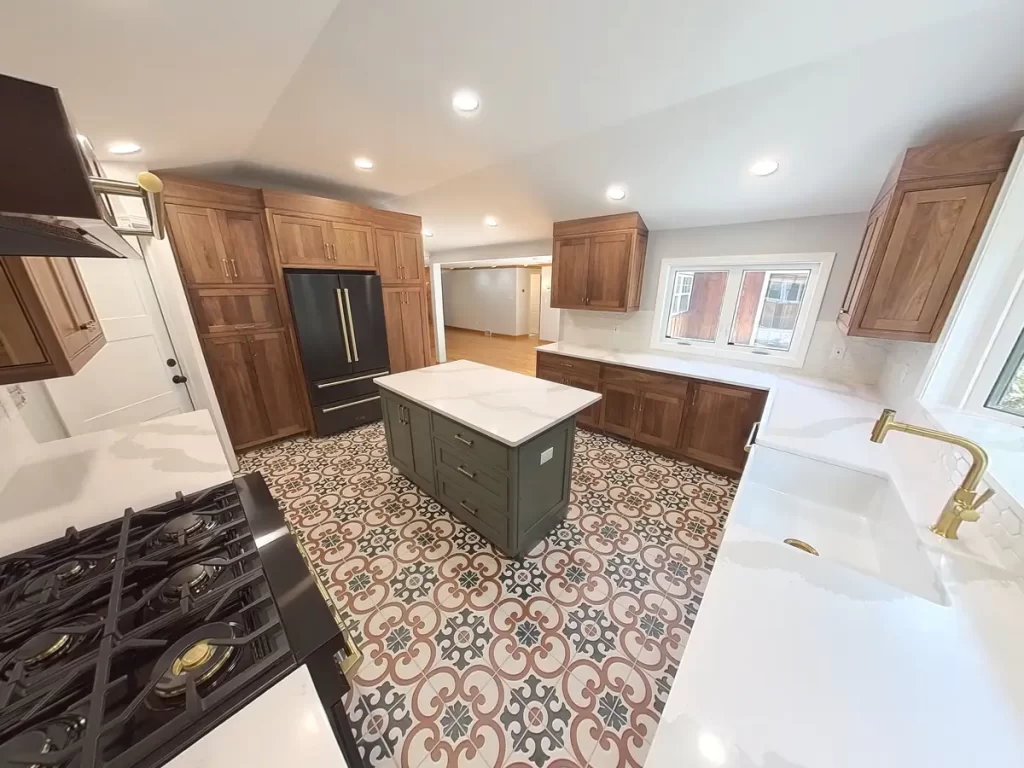 Top-down view of Elma, NY, remodeled kitchen showing bright white countertops, patterned flooring, and modern cabinetry.