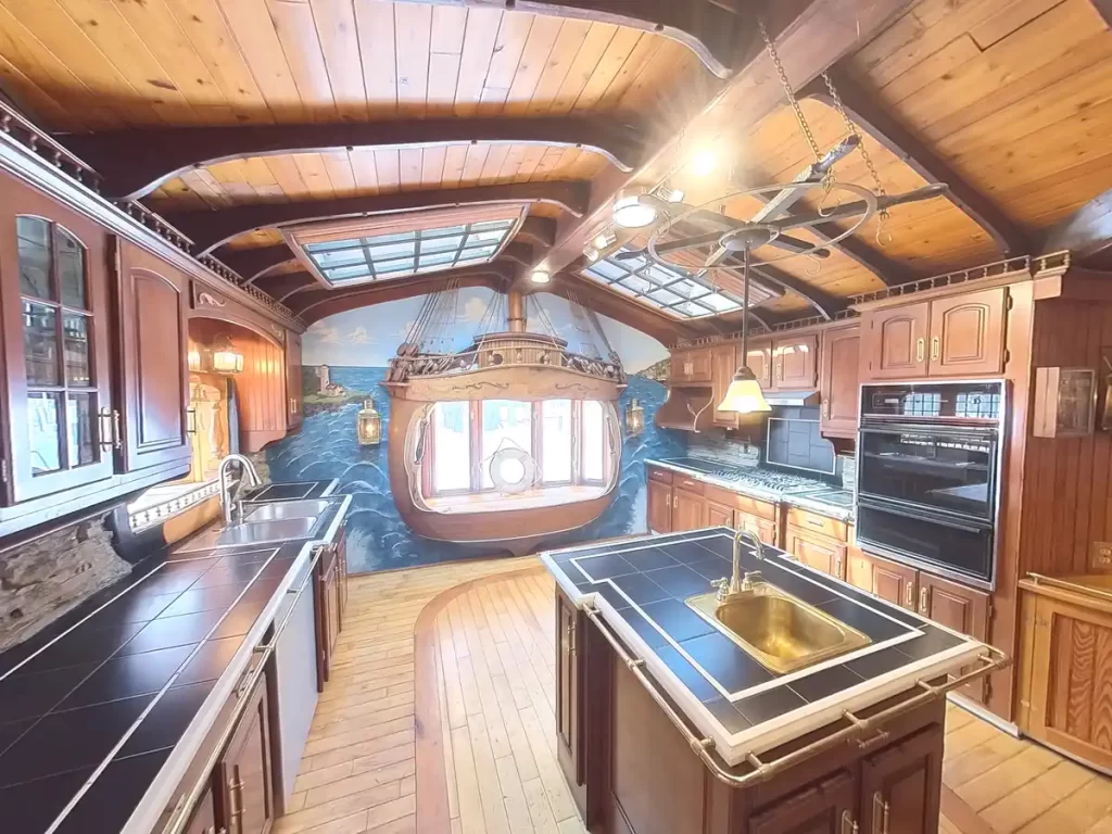 Before image of ship-themed kitchen in Elma, NY, highlighting wooden countertops, decorative ship features, and skylight ceiling.