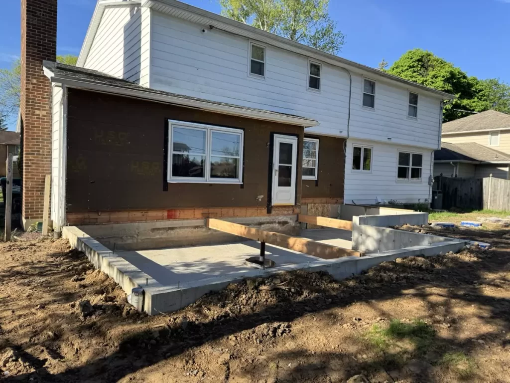 Concrete poured into foundation forms for a new home addition in Amherst, NY by Stately General Contracting.