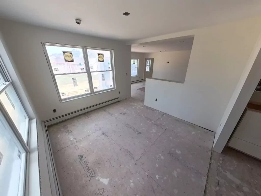 Bright, open space with drywall completed in Stately’s Amherst, NY addition project, showcasing window and layout details.