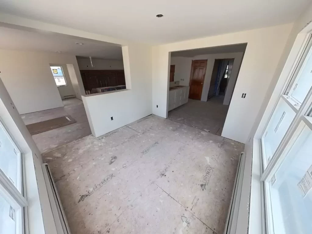 Dining area in home addition, Amherst, NY, with drywall installation by Stately, showing progress toward finished living space.