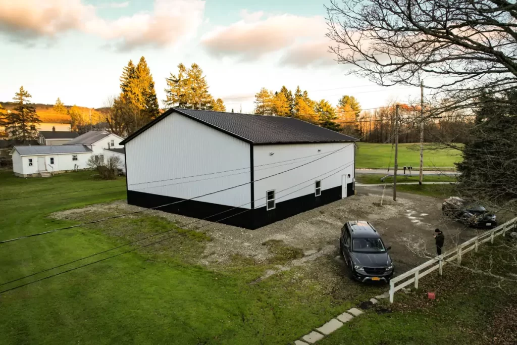 Rear view of a Stately pole barn with a Perma-Column foundation in Holland, NY, featuring top-notch materials.