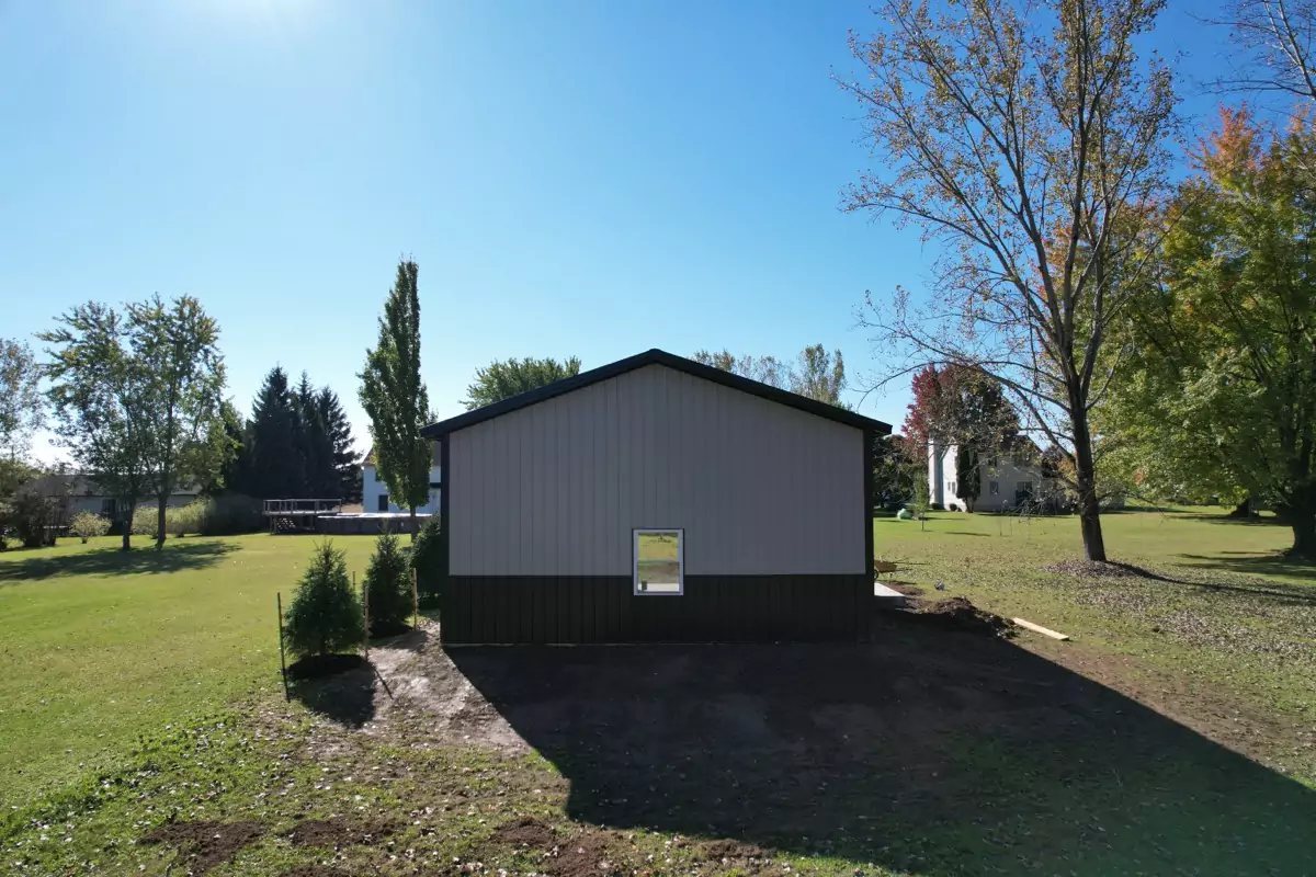 Back view of Stately Pole Barn, featuring a black and gray exterior and single-hung vinyl window.