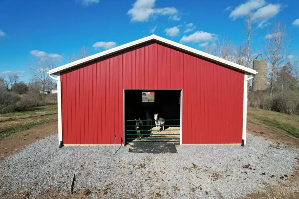 Rear view of pole barn in rural Gasport, NY, with large opening for access and robust construction details.