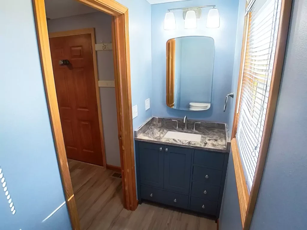 Custom Reusch Woodworking bathroom vanity with a stone countertop from International Stone Gallery.