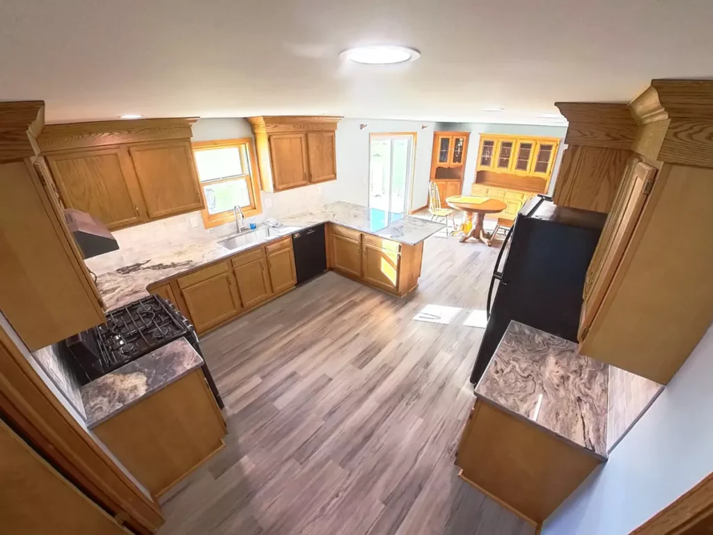 Stately kitchen design in Akron, NY featuring refinished cabinetry and a contemporary backsplash.