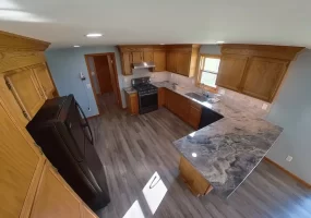 Bright and open Stately kitchen remodel with recessed lighting and premium vinyl plank flooring.