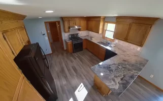 Bright and open Stately kitchen remodel with recessed lighting and premium vinyl plank flooring.