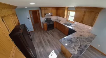 Bright and open Stately kitchen remodel with recessed lighting and premium vinyl plank flooring.